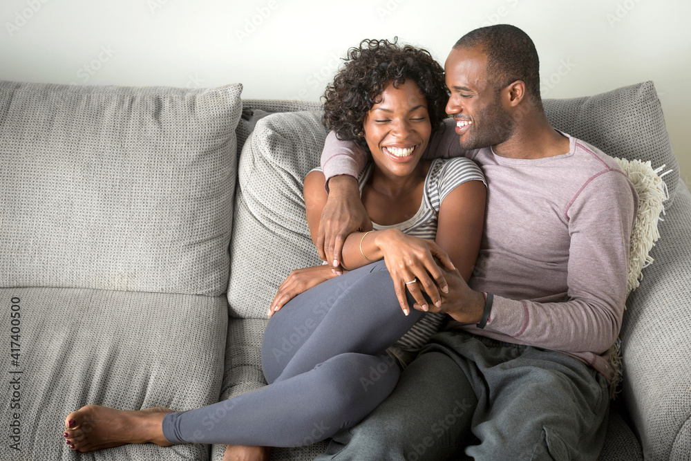 Portrait of mid adult couple sitting on sofa Portrait of mid adult couple sitting on sofa