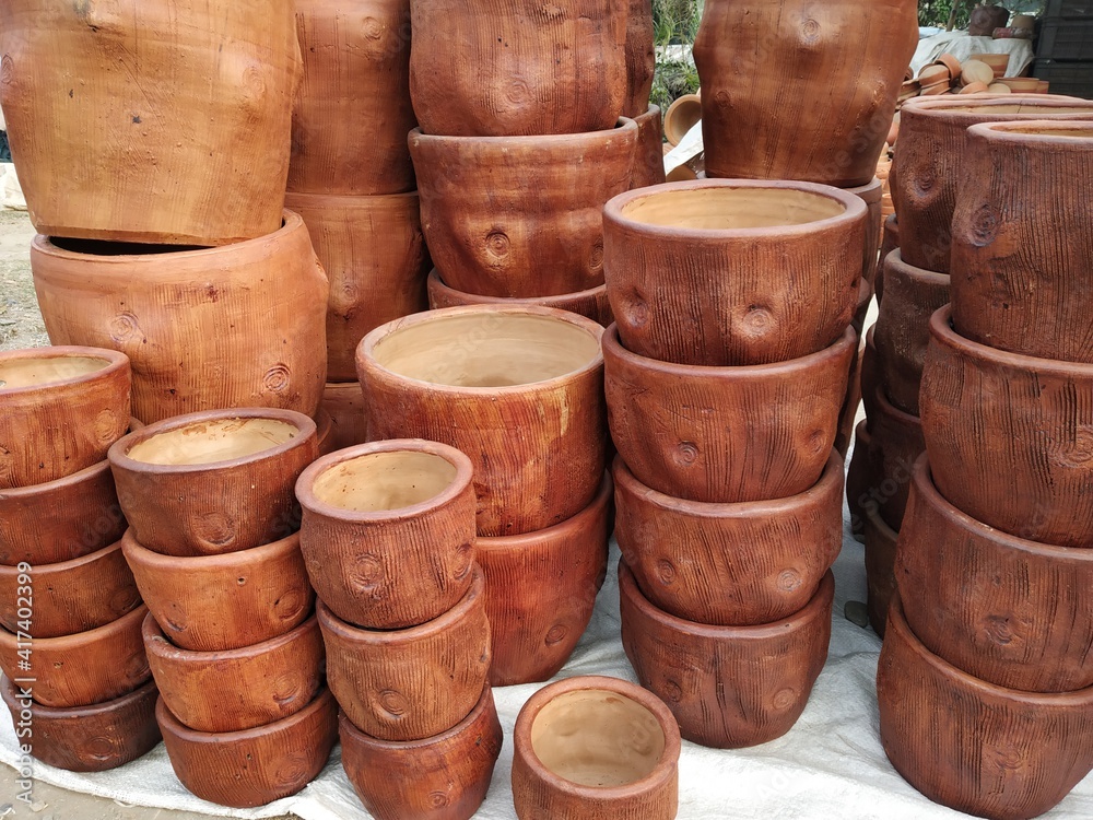 Earthen plant pot stack in a roadside shop near at Matigara, Siliguri, West Bengal, India. shot on 14 February 2021. Earthen plant pot stack in a roadside shop near at Matigara, Siliguri, West Bengal, India. shot on 14 February 2021.