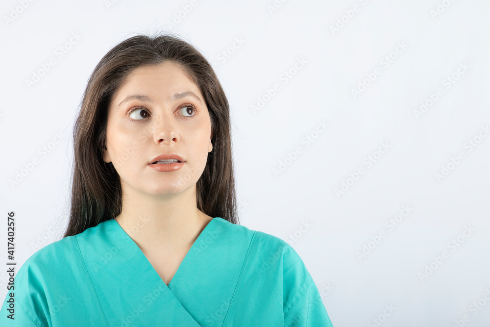 Portrait photo of a young beautiful woman in green uniform Portrait photo of a young beautiful woman in green uniform