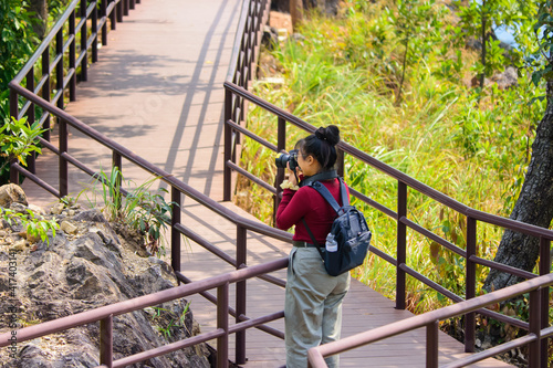 Tourists stand take photo to travel at on the nature trail at Chae Son National Park Lampang Thailand...