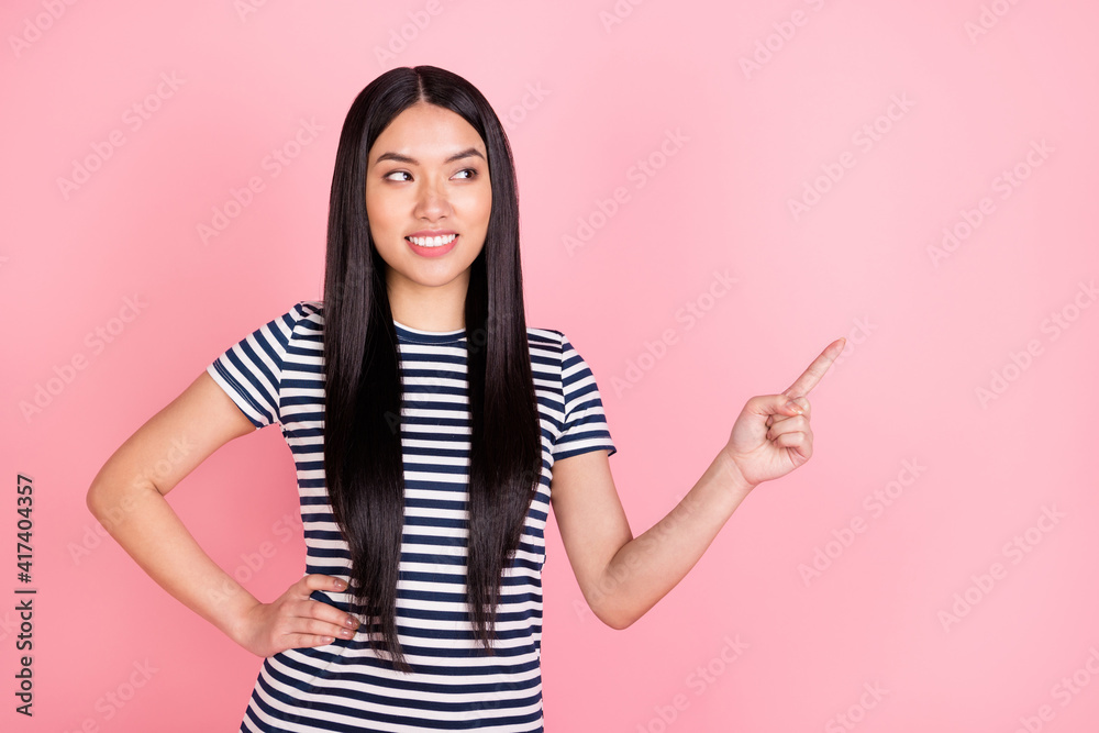 Photo portrait of brunette girl curious pointing finger blank space recommending isolated on pastel pink color background Photo portrait of brunette girl curious pointing finger blank space recommending isolated on pastel pink color background