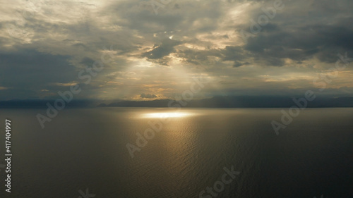 Colorful bright clouds during sunset over the sea, aerial view. Sunset over ocean. Seascape, Summer and travel vacation concept, Moalboal, Philippines.
