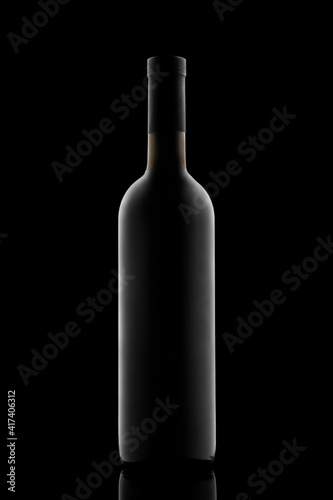illuminated silhouette of a bottle with wine on a black background