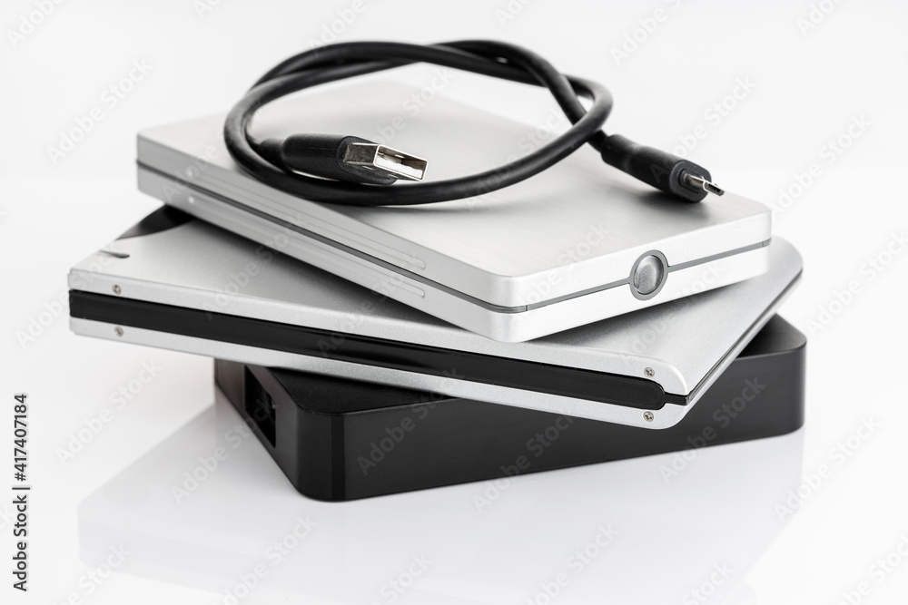 Pile of a group of external Hard disk drive on white table Pile of a group of external Hard disk drive on white table