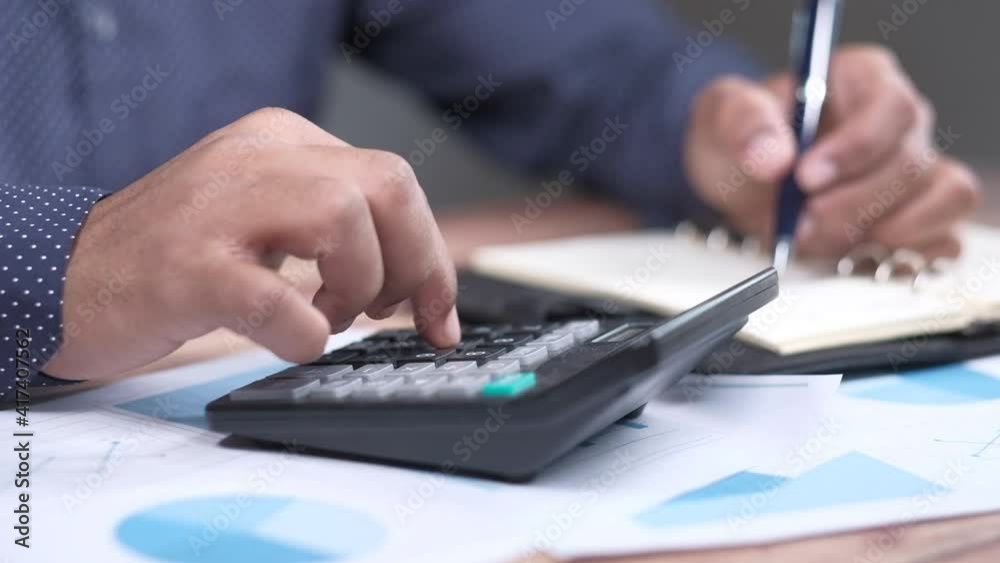 Close up of man hand using calculator Close up of man hand using calculator