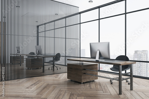 City view from big window in modern light office with dark wooden table and floor