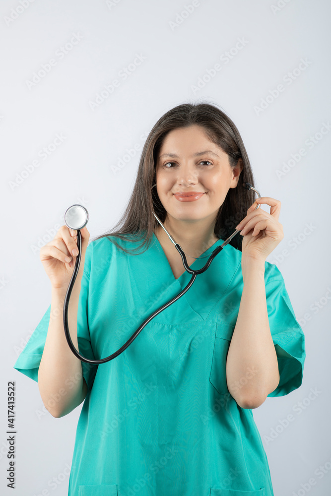 Portrait of a young woman doctor with stethoscope in uniform. Portrait of a young woman doctor with stethoscope in uniform.