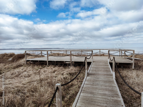 Photo of wooden pier with observation deck entering the sea in north Germany on Baltic sea