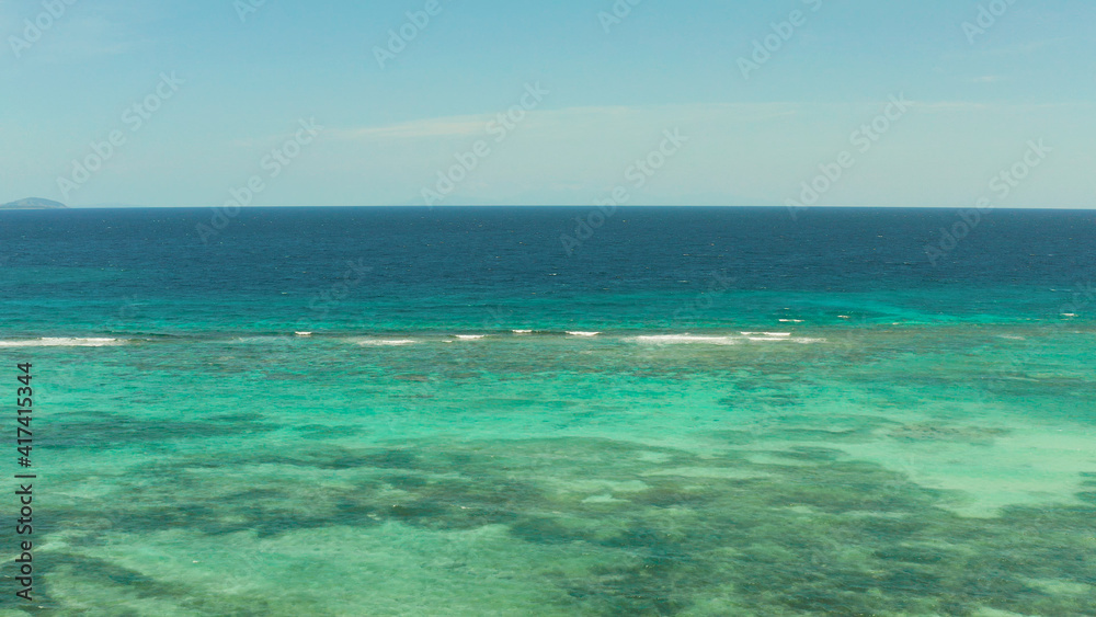 Sea water surface in lagoon, copy space for text, aerial view. Top view transparent turquoise ocean water surface. background texture