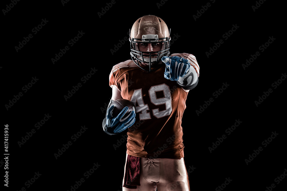 Fototapeta Football Player with a orange uniform coming out of a stadium tunnel.