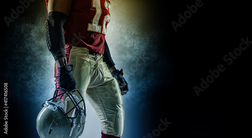 Sportsman with ball in helmet on stadium in action. Sport wallpaper. Team sports. photo