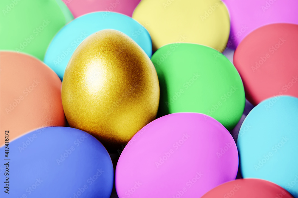 Gold egg on hiding in between colorful easter eggs Gold egg on hiding in between colorful easter eggs