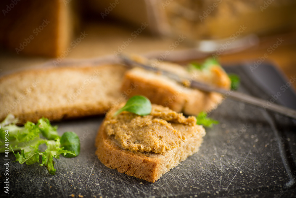 homemade meat pate with bread on a wooden table homemade meat pate with bread on a wooden table