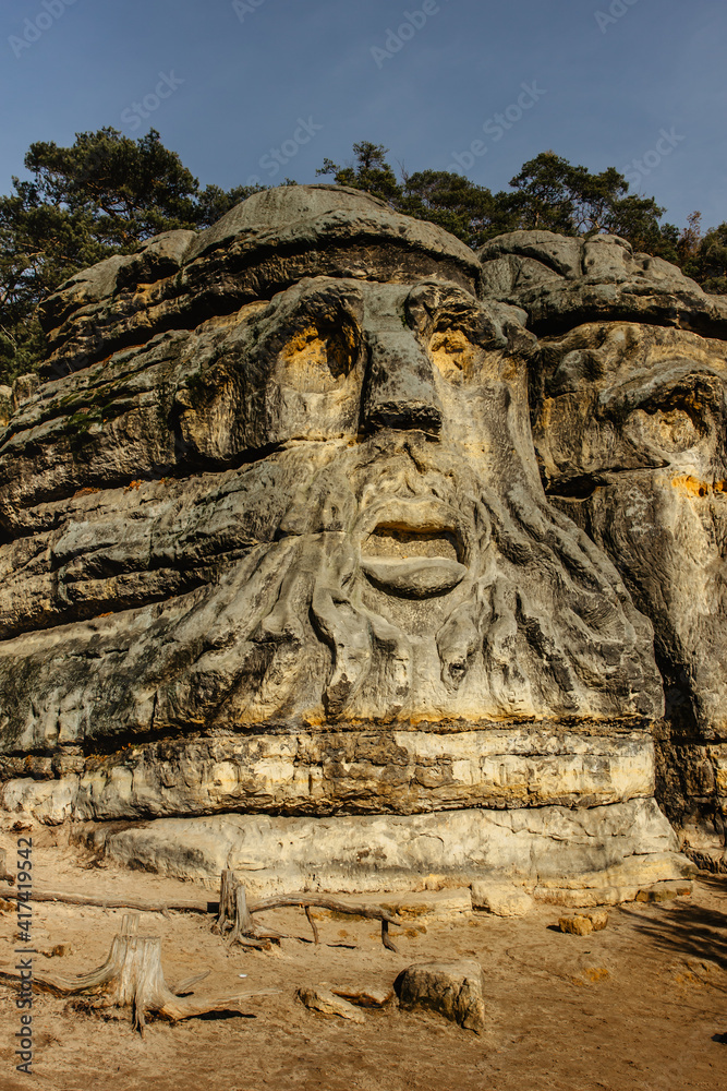 Two giant heads of devils carved into sandstone rocks,each is about 9m high.Devils Heads created by Vaclav Levy near Libechov, Czech republic.Cliff carvings carved in pine forest.Tourist attraction.