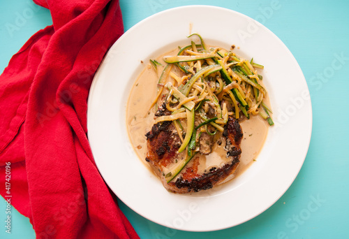 seared pork chop with zucchini photo