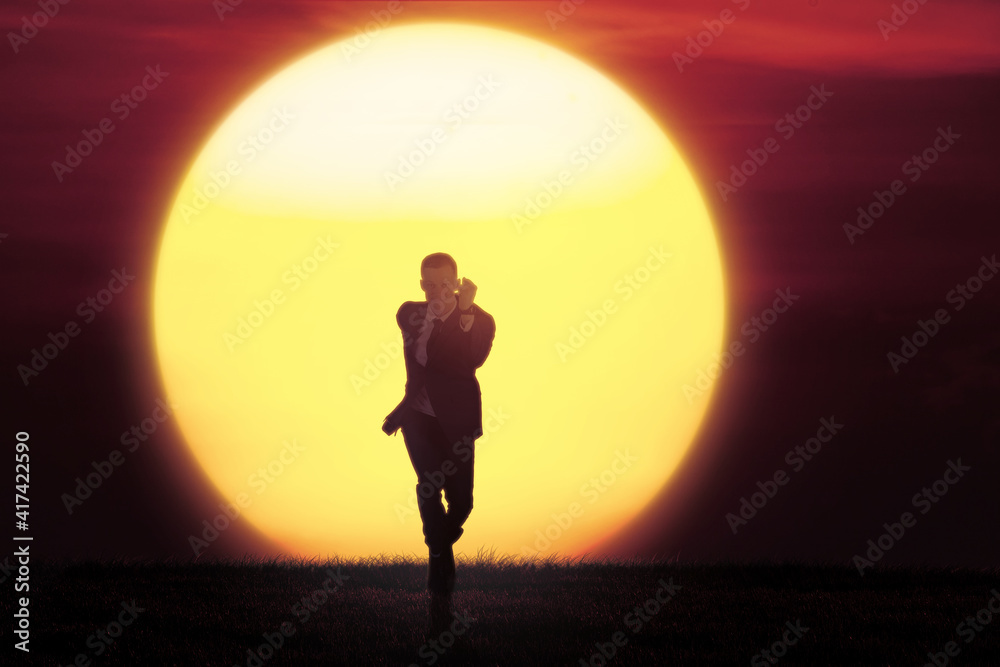 Male manager sprinting with sunrise background