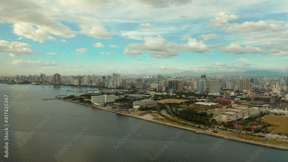 Aerial view of Panorama of Manila at sunset. Skyscrapers and business centers in a big city. Travel vacation concept
