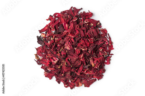 Red tea hibiscus in spoon isolated on white in studio