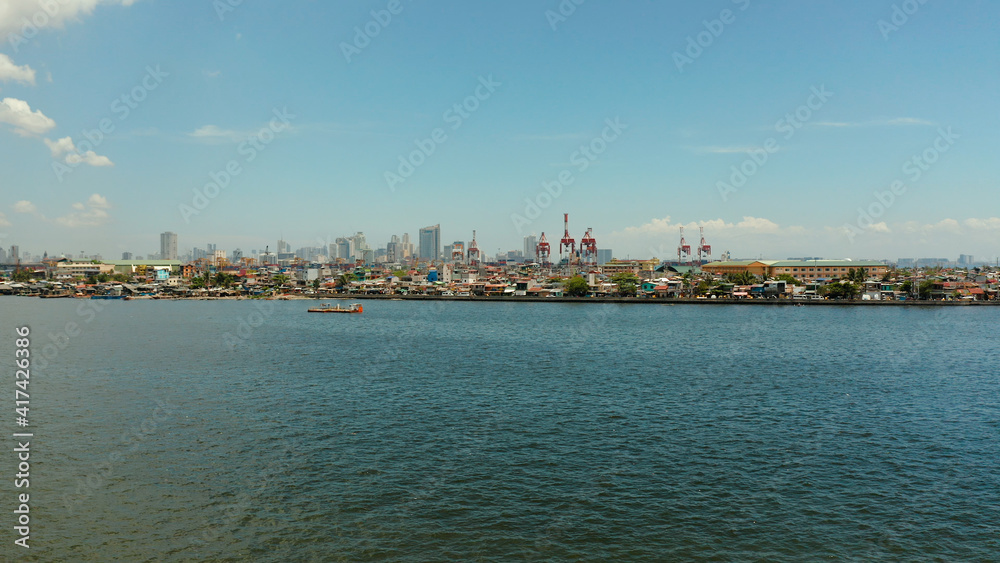 Manila city with port, skyscrapers, modern buildings and Makati business center aerial drone. Travel vacation concept