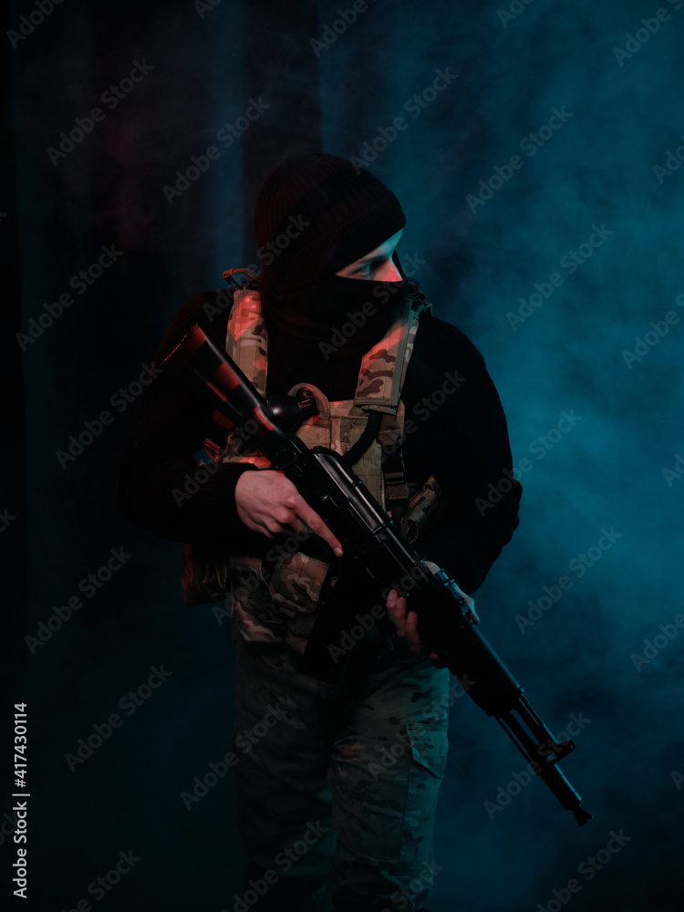 Special forces fighter with weapons on a background of smoke