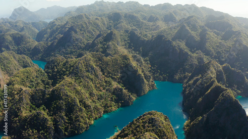 Fototapeta Naklejka Na Ścianę i Meble -  Aerial drone Kayangan lake with blue water on tropical island Coron. Lake in the mountains covered with tropical forest. Palawan, Philippines