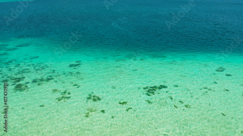 Sea water surface in lagoon with coral reef copy space for text. Top view transparent turquoise ocean water surface. background texture © Alex Traveler