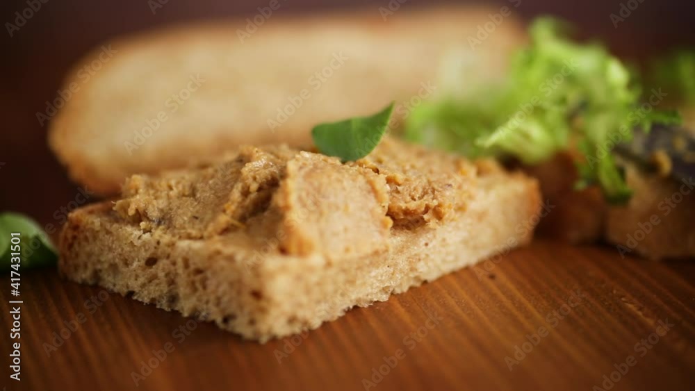 homemade meat pate with bread on a wooden table