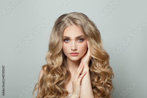 Young woman with healthy curly hairstyle portrait