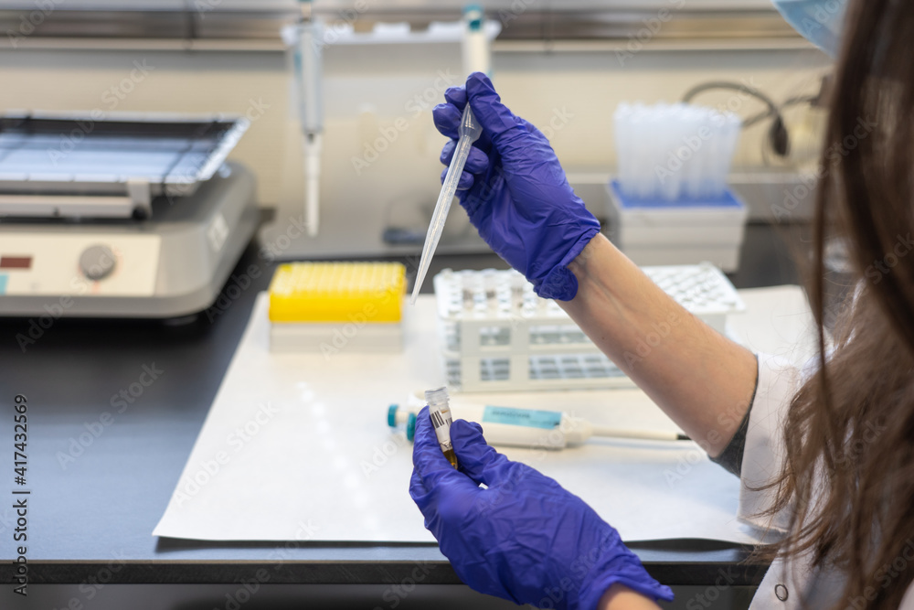 woman in laboratory doing tests for vaccine blood extraction and analytical woman in laboratory doing tests for vaccine blood extraction and analytical