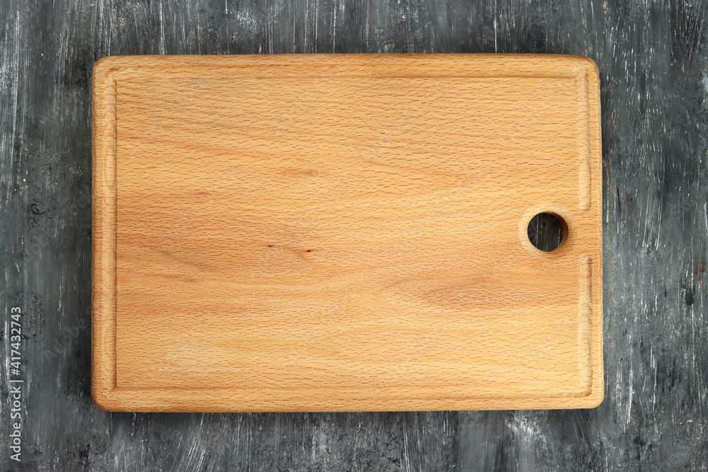 Rectangular cutting board on a gray table Rectangular cutting board on a gray table
