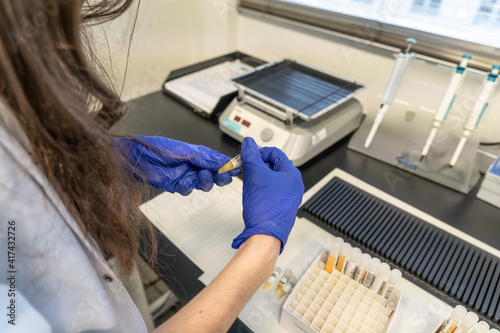 woman in laboratory doing tests for vaccine blood extraction and analytical