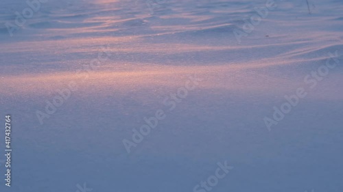 Snow blizzard sweeps snow. Sunset. Slow motion.