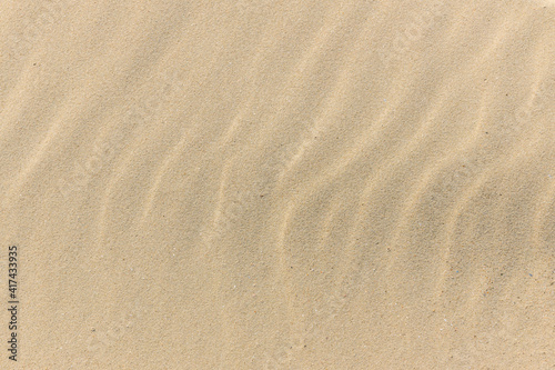 Natural sand stone texture background. sand on the beach as background. Wavy sand background for summer designs.