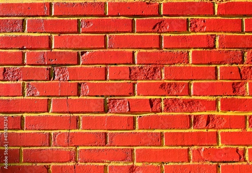 Grunge brick wall painted red and yellow. Background and texture. Copy space photo