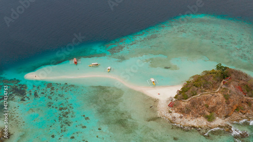 aerial seascape tropical island and sand beach, turquoise water and coral reef. malacory island, Philippines, Palawan. tourist boats on coast tropical island. photo