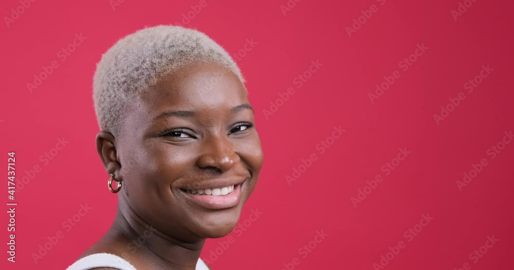African american woman smiling over red background African american woman smiling over red background