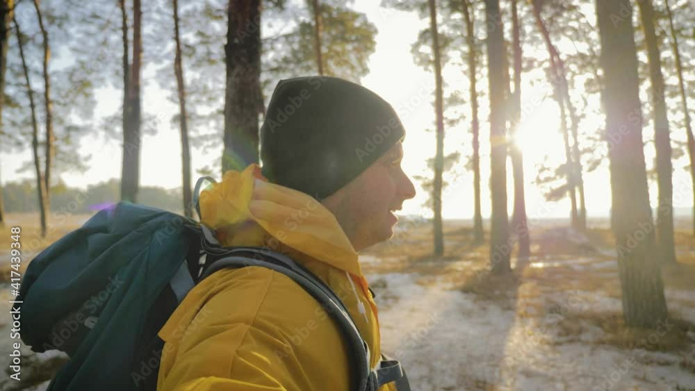 Man hiker backpacker, traveler camper with her phone. Hiking, backpacking on winter.