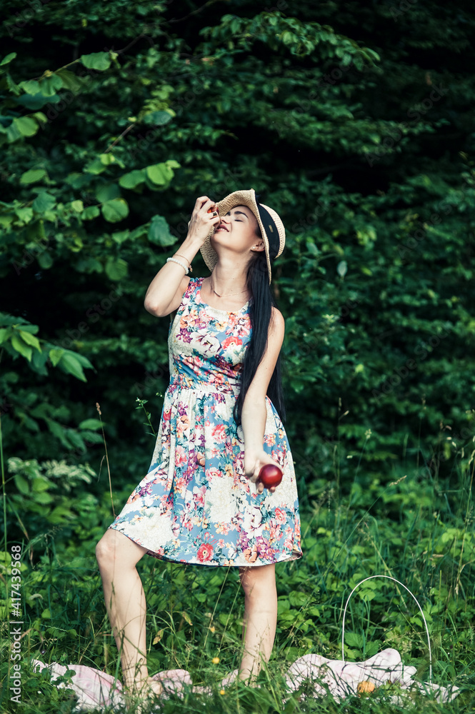 Girl on a picnic eats fruit. Girl on a picnic eats fruit.