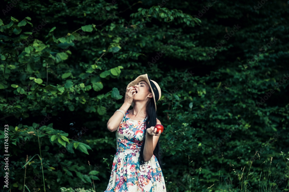 Girl on a picnic eats fruit. Girl on a picnic eats fruit.