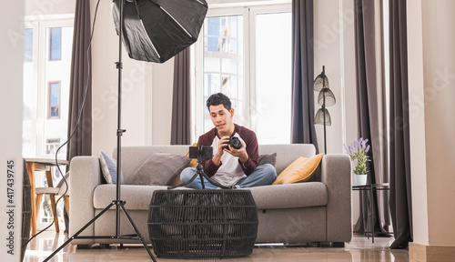 Young blogger man creating content for social media while making a video at home.