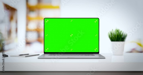 Modern laptop with blank frameless screen smooth zoom in - white table with mouse and notepad. Home interior or office background, 4k 30fps UHD