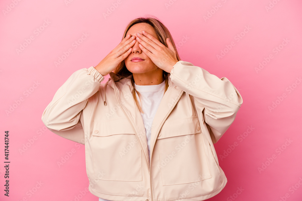 Young mixed race woman isolated on pink background afraid covering eyes with hands. Young mixed race woman isolated on pink background afraid covering eyes with hands.