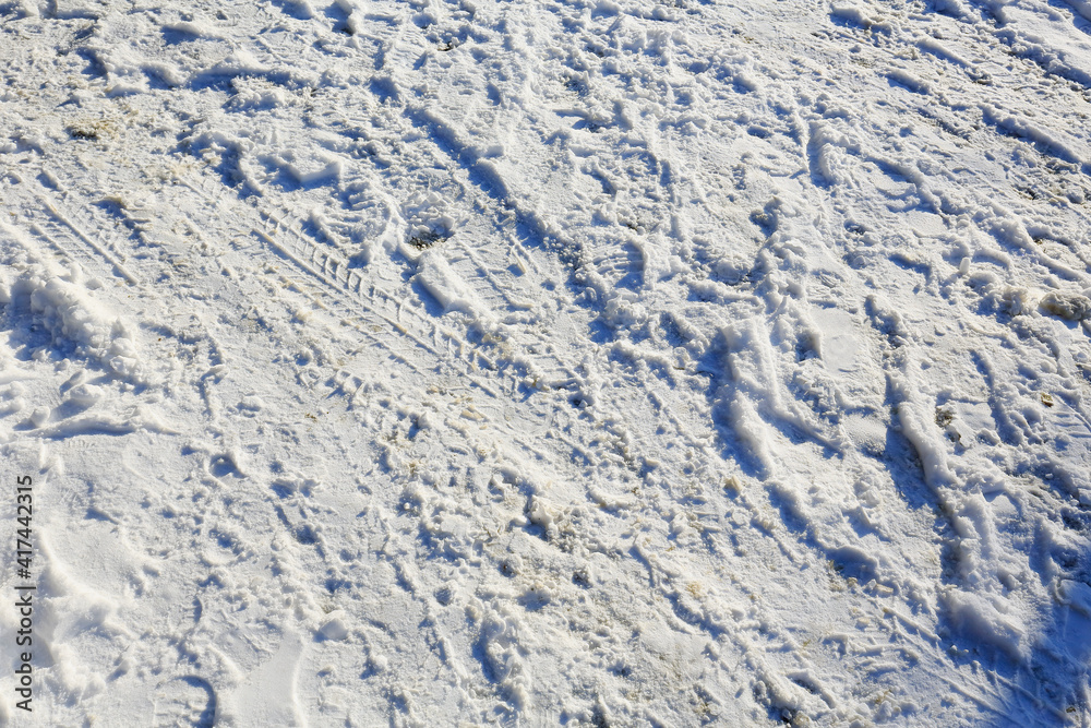 Fototapeta premium Snow with boot tracks and traces of the tread on it