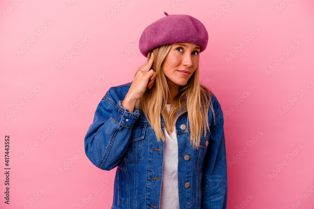 Young mixed race woman isolated on pink background covering ears with hands. Young mixed race woman isolated on pink background covering ears with hands.