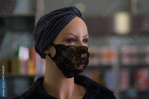 head of a mannequin in a lacy black mask. fashion adjusts to the new norm. photo