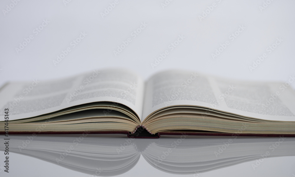 Fototapeta premium the reflection of a book on a white table