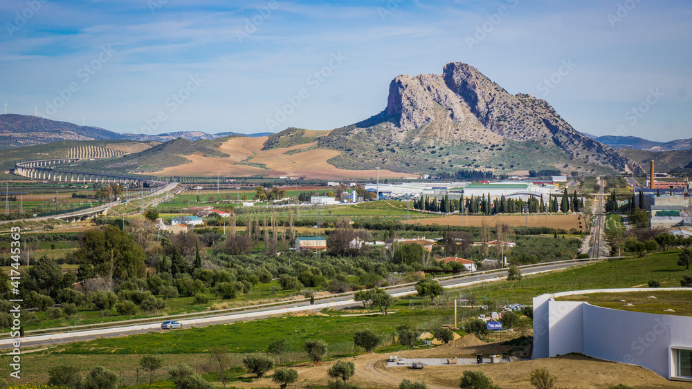 View on the Pena de Los Enamorados, a mountain near the small town of Antequera in Andalusia, Spain. In the foreground, the museum of the dolmens of Antequera