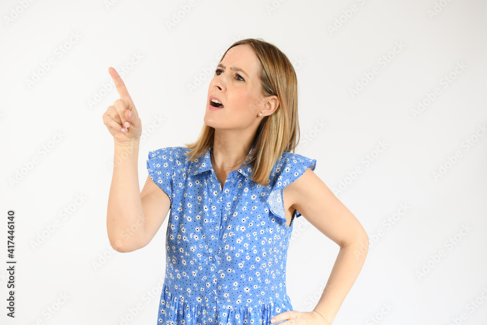 Young woman over isolated white background pointing finger to the side Young woman over isolated white background pointing finger to the side
