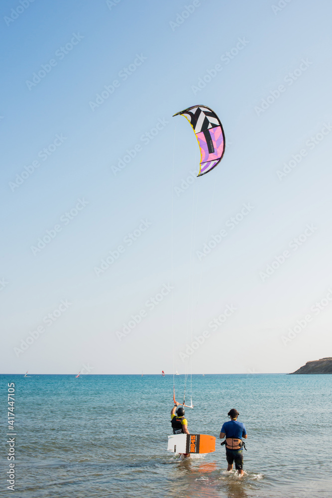 Two people practising kytesurf at Prasonisi beach, Rhodes, Dodecanese, Greece. Sunny day. Two people practising kytesurf at Prasonisi beach, Rhodes, Dodecanese, Greece. Sunny day.