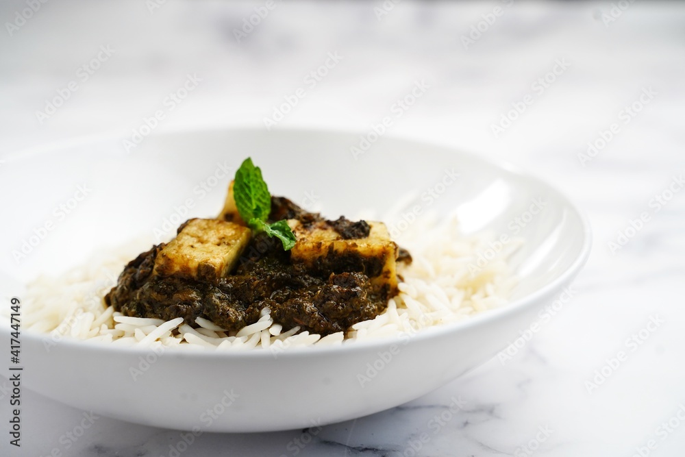 Palak Paneer or Saag Paneer with steamed basmati rice on white background Palak Paneer or Saag Paneer with steamed basmati rice on white background